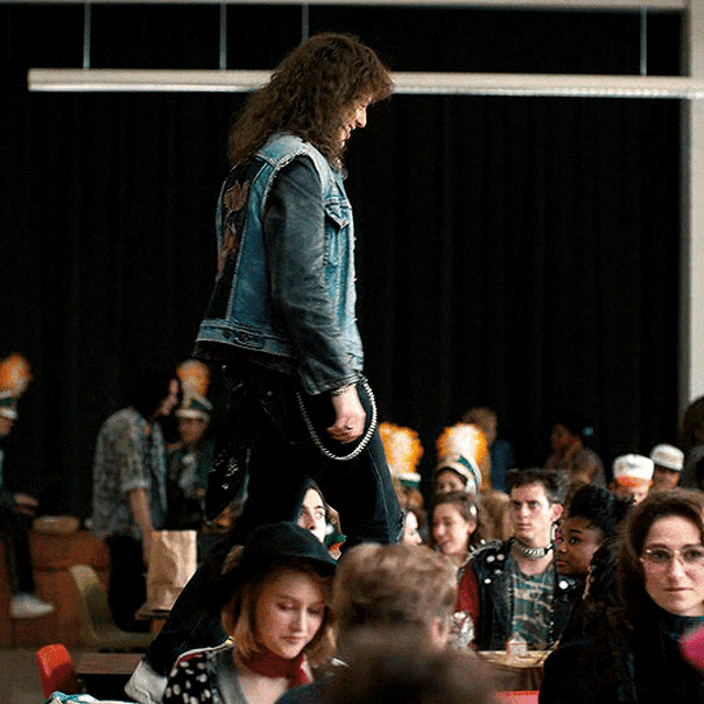 a man wearing a denim vest with ac dc on the back