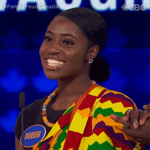 a woman wearing a name tag that says doreen is smiling and holding someone 's hand .