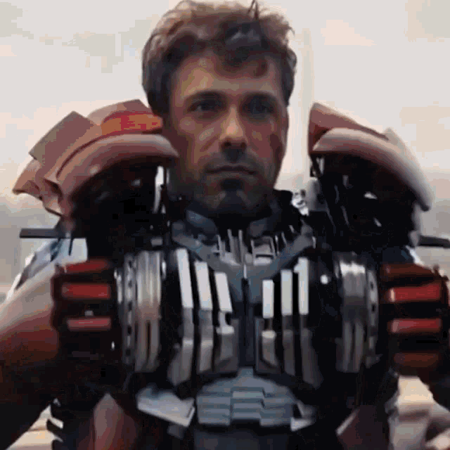 a close up of a man wearing a red and silver iron man suit