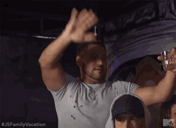 a man in a white shirt holds a shot glass in his hand with the hashtag # jsfamilyvacation