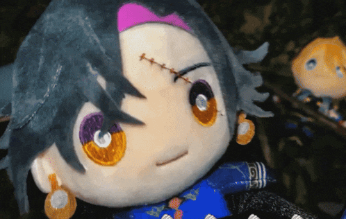 a close up of a stuffed toy with stitches in his face