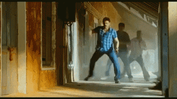 a man in a blue plaid shirt is jumping in the air