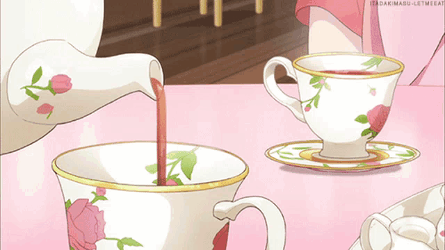 a cup of tea is being poured from a teapot into a cup