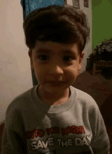 a young boy is wearing a shirt that says to the night save the day