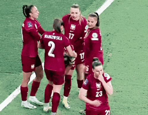 a group of female soccer players one of whom has the number 2 on her shirt