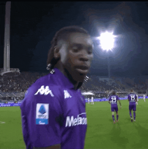 a soccer player wearing a purple kappa shirt