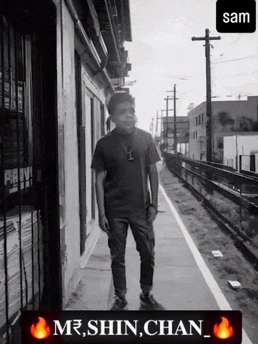 a black and white photo of a man standing on a sidewalk with the name sam at the bottom