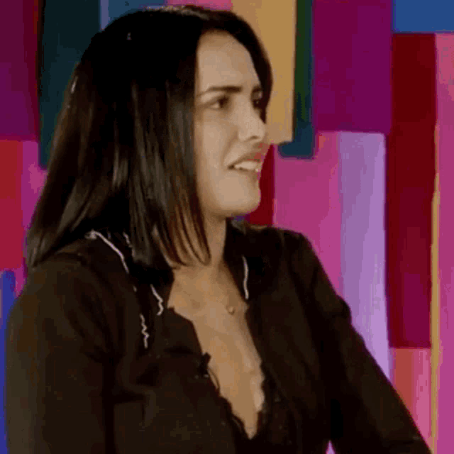 a woman in a black shirt is making a funny face .