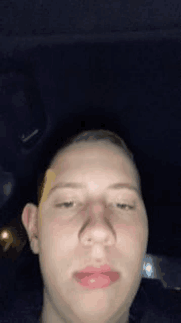 a close up of a man 's face in a car .