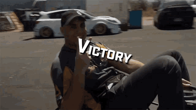 a man laying on the ground with the word victory on his chest