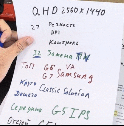 a person is holding a piece of paper that says qhd 2560 x 1440 on it