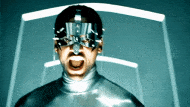 a man wearing a mask with spikes on his face