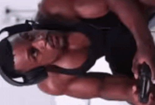 a man is wearing headphones and holding a video game controller .