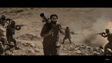 a man carrying a rocket launcher is surrounded by soldiers and the word veo is on the bottom