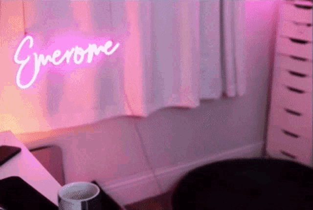 a neon sign that says everyone is lit up in a pink room
