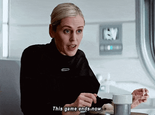 a woman sitting at a table with a cup of coffee says " this game ends now "