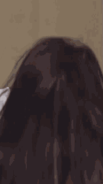 a close up of a person 's face with a white shirt on
