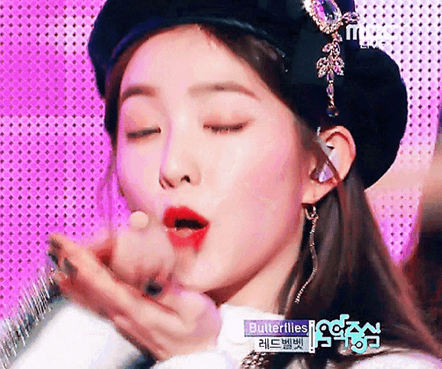 a close up of a woman wearing a beret with the words butterflies on the bottom right