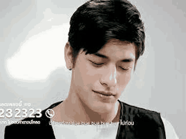 a close up of a young man 's face with his eyes closed and a caption .