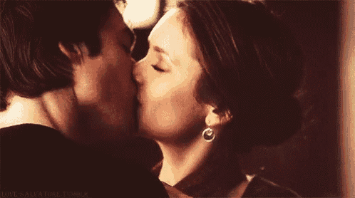 a man and a woman are kissing each other .