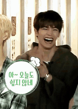 a young man is laughing with a speech bubble that says ' a ~ ' on it