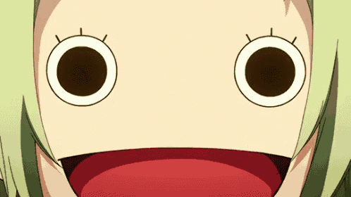 a close up of a girl 's face with a red mouth and big eyes