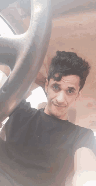 a man in a black shirt is taking a selfie