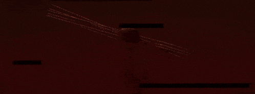 a person is holding a sword in their hand in a dark room .
