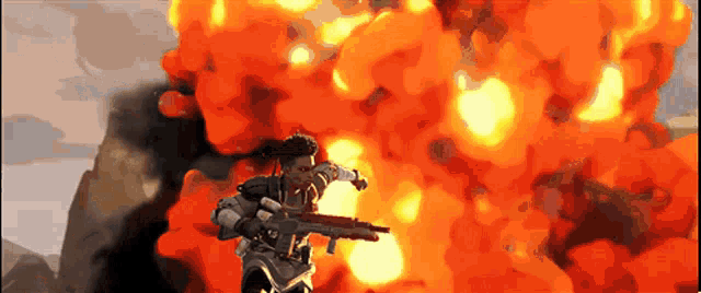 a man holding a gun in front of a huge explosion