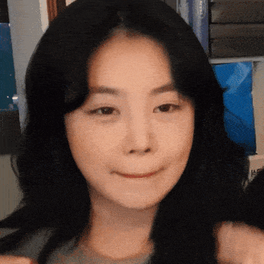 a close up of a woman 's face with a sign in the background that says ' a ' on it