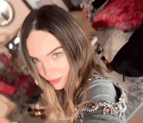 a close up of a woman taking a selfie with her phone