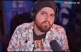 a man with a beard is wearing headphones and a beanie .