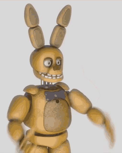 a yellow bunny with a blue bow tie on his chest