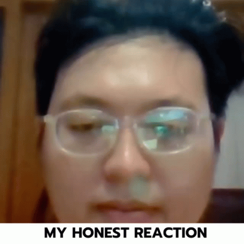 a close up of a person wearing glasses with the words " my honest reaction " below them