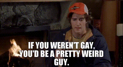 a man in a baseball cap is standing in front of a fireplace with a quote that says if you weren 't gay