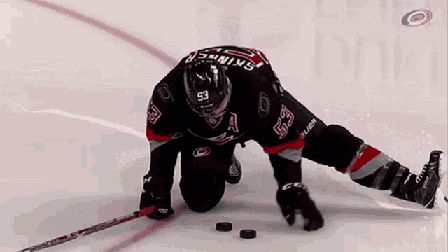 a hockey player with the number 53 on his jersey is on the ice