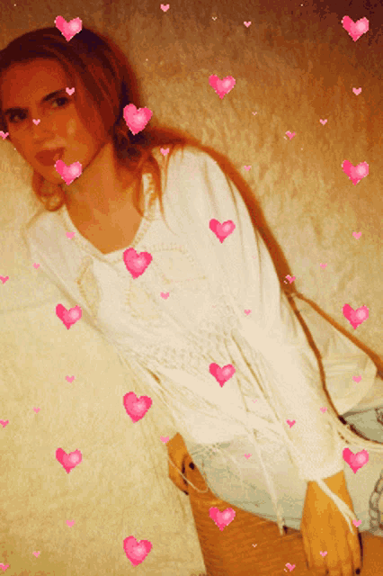 a woman is surrounded by pink hearts and a white shirt