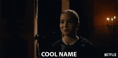 a girl is standing in a dark room and the words cool name are on the screen