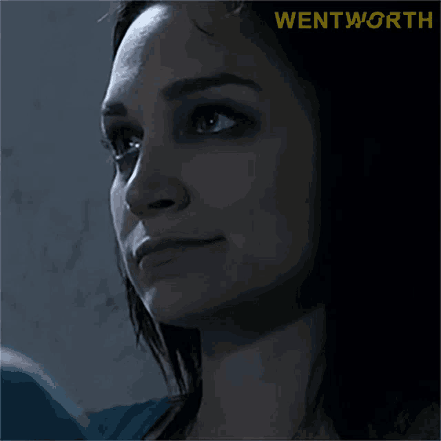 a close up of a woman 's face with the word wentworth in yellow