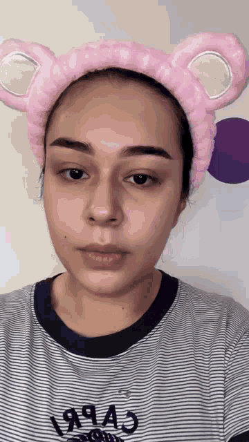 a woman wearing a headband with ears and the year 1994 on her shirt