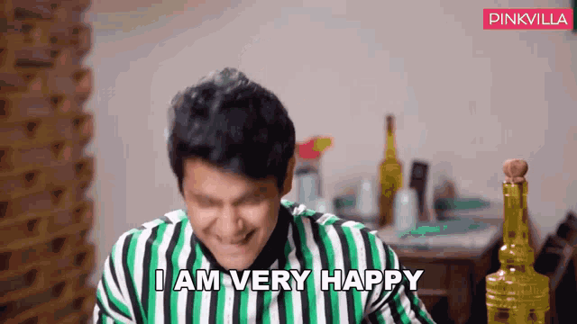 a man in a green and white striped shirt is very happy
