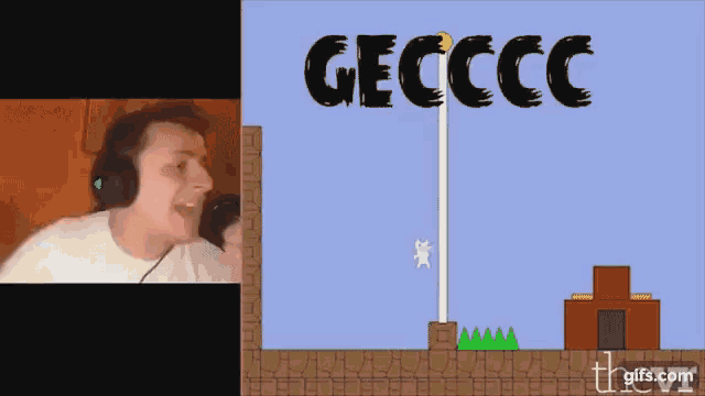 a man wearing headphones looks at a video game screen with the word geccc on it
