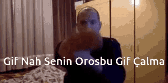 a man is holding a stuffed animal and says gif nah senin orosbu gif çalma