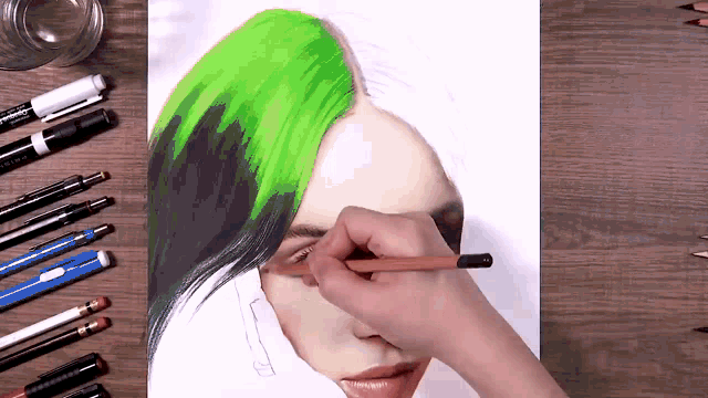 a person is drawing a woman 's face with green and black hair