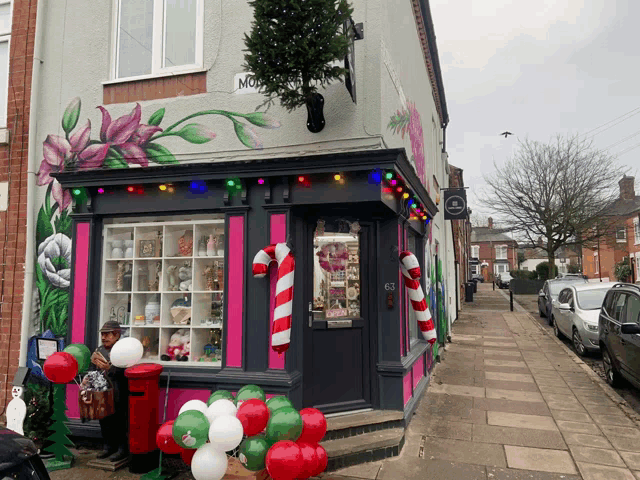 a store front with a candy cane and balloons