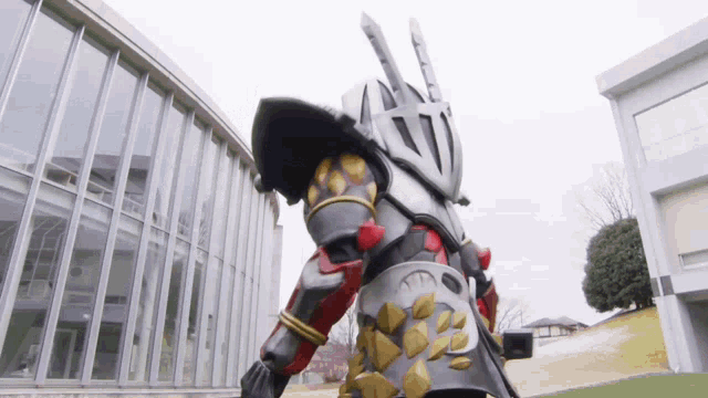 a knight costume is standing in front of a building with a lot of windows
