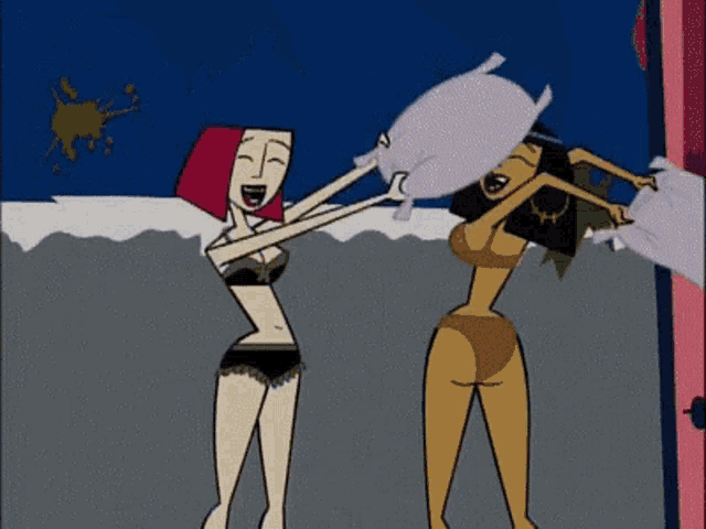 two women in bikinis are having a pillow fight on the beach