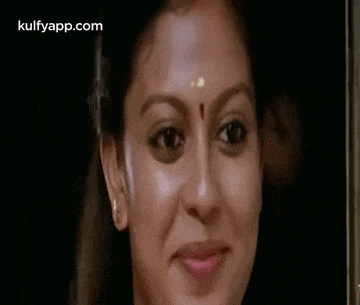 a close up of a woman 's face with a smile on it .