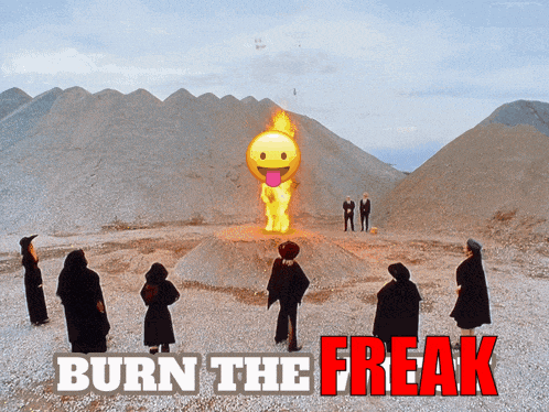 a group of people standing around a burning smiley face with burn the freak written on the bottom