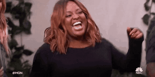 a woman in a black shirt is laughing with the hashtag #hgn